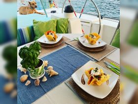 A beautifully arranged dining setup on a boat featuring delicious food and a cozy atmosphere, perfect for enjoying meals while cruising on the water.