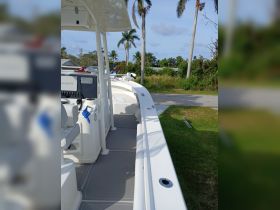 A detailed view of the helm and seating area inside a boat, showcasing the modern console and comfortable seating, perfect for a day on the water.