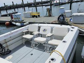 Interior view of a boat featuring comfortable seating arrangements, ideal for relaxing while enjoying a day on the water.