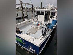 An interior view of a fishing boat showcasing the helm and equipment, ideal for anglers looking to enjoy a day on the water.