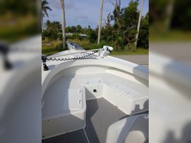 Interior view of a boat's helm area, showcasing seating and storage compartments — ideal for comfortable cruising and fishing trips.