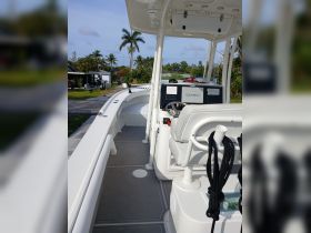 A clean and modern helm area of a boat featuring a Garmin display and comfortable seating, perfect for navigating the waters.