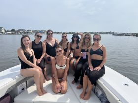 A lively group of friends enjoys a fun day on the water, soaking up the sun aboard a pontoon boat — perfect for summer celebrations and gatherings.