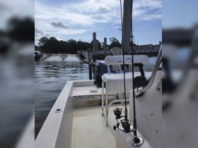 A view of the interior of a fishing boat, showcasing the seating and helm area, perfect for a day out on the water.