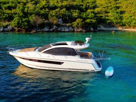 A stunning aerial view of a sleek yacht anchored in clear turquoise waters, showcasing its elegant design and perfect for luxury boating experiences.