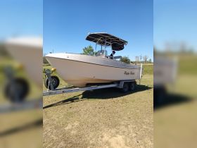 A well-maintained boat named 'Happy Hunter' is docked on land, showcasing its sleek design and ready for the next adventure.