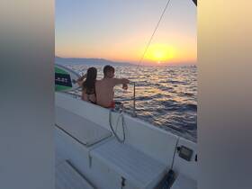 A couple enjoys a romantic sunset view while sailing, creating the perfect backdrop for memorable moments on the water.