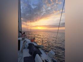 A serene sunset view from a sailing boat, with guests enjoying the picturesque scenery — perfect for romantic evenings on the water.