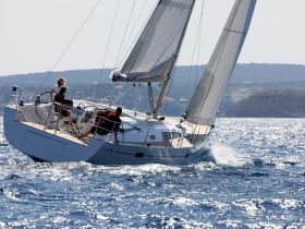 A group enjoys an exhilarating sailing experience on a yacht, showcasing the thrill of on-water activities and the beauty of the open sea.