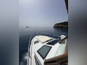 A serene view from the front of a boat, showcasing the calm waters and distant coastline, perfect for a relaxing day on the water.