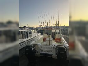 A fishing boat named 'Deepsea 7' is docked, showcasing its fishing rods and equipment, perfect for deep sea fishing adventures.