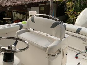 A close-up view of the helm seating area on a boat, showcasing the comfortable design and layout ideal for navigation.