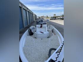 Interior view of a well-equipped boat helm featuring a comfortable seating area and ample space for fishing gear, ideal for a day on the water.