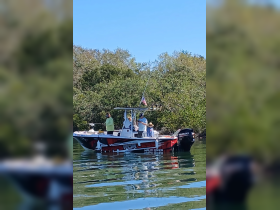 A group of people enjoying a day on the water aboard a fishing boat, showcasing the fun and camaraderie of a fishing trip.