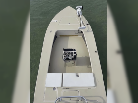 An overhead view of the helm and seating area inside a boat, showcasing the clean and functional design ideal for a day on the water.