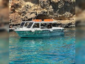 A boat navigates through crystal-clear waters, showcasing a vibrant scene of relaxation and adventure amidst stunning natural surroundings.