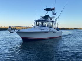 A fishing boat named 'Christina P' navigates through calm waters, showcasing the perfect setting for a day of fishing and adventure.