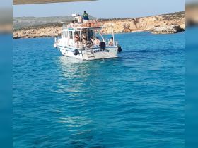 The 'Lucky Lady' boat cruises through crystal-clear waters, with guests enjoying the scenic views along the coastline — a perfect day for exploration and adventure.
