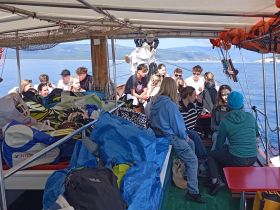 A lively group of young people enjoys their time aboard a boat, creating memorable moments on the water. Perfect for group outings and celebrations.