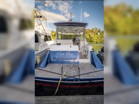 The rear view of the 'Déjà Blue' boat docked, showcasing its sleek design and inviting atmosphere, perfect for exploring the waters of St. Thomas, USVI.