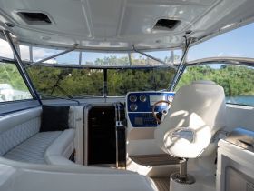 A sleek interior view of a boat's helm and seating area, showcasing modern design and comfort for an enjoyable boating experience.