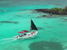 A lively group enjoys a sailing adventure on turquoise waters, perfect for island hopping and creating unforgettable memories.
