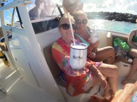 A joyful group of friends enjoys cocktails on a boat, capturing the essence of a fun day on the water. Perfect for celebrating special moments with loved ones.