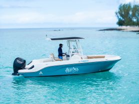 A sleek speedboat named 'Aqua Sea' glides through crystal-clear waters, showcasing its stylish design and perfect for thrilling adventures on the water.