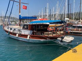 A beautifully docked yacht showcasing its elegant design and vibrant colors, perfect for exploring coastal waters.
