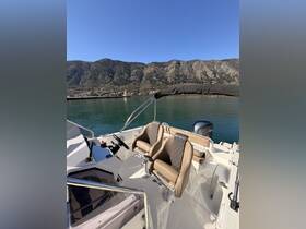 Interior view of a boat's helm and seating area, showcasing comfortable captain's chairs and control console, perfect for navigating scenic waters.