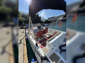 A well-appointed interior view of a boat showcasing comfortable seating and a helm, perfect for a day on the water.