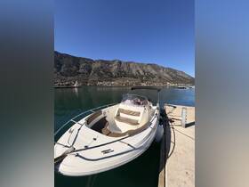 A sleek speedboat docked at a serene waterfront, surrounded by stunning mountain views — perfect for day trips and water adventures.