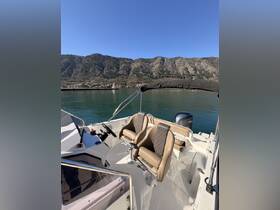 Interior view of a boat's helm and seating area, showcasing comfortable captain's chairs and a well-equipped console, perfect for navigating scenic waters.