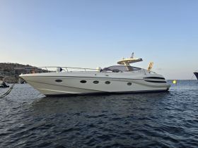 A stunning yacht docked in calm waters, showcasing its sleek design and elegant profile against a serene backdrop.