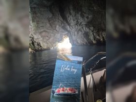 Exploring the stunning Boka Bay, this image captures the breathtaking cave scenery illuminated by sunlight, perfect for adventure seekers and nature lovers.