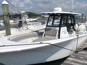 A sleek speedboat docked at the marina, showcasing its modern design and spacious seating — perfect for a day out on the water.