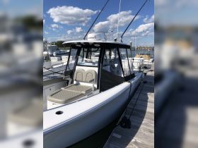 A detailed view of the interior helm and seating area of a boat, showcasing modern design and comfort features, perfect for fishing or cruising.
