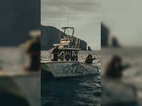 A group of anglers aboard a fishing boat, casting lines into the ocean, showcasing the thrill of a fishing adventure.