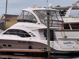 A sleek yacht named 'Encore' docked at the marina, showcasing its elegant design and spacious layout, perfect for luxury outings on the water.