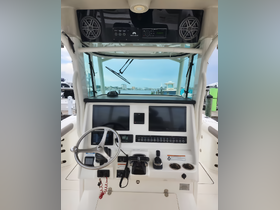 A detailed view of the helm and console area inside a boat, showcasing modern navigation equipment and controls, perfect for boating enthusiasts.
