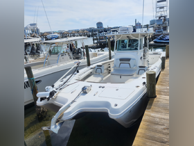 A sleek center console boat docked at the marina, showcasing its modern design and features — perfect for fishing or day cruising.
