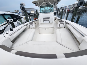 A spacious and well-designed interior of a boat featuring comfortable seating and a helm area, perfect for relaxing or navigating on the water.