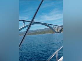 A stunning view of a bridge from a boat, showcasing the beautiful coastline and clear waters — perfect for scenic boat tours.