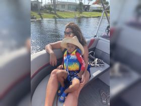 A mother and her young child enjoy a relaxing moment on a boat, showcasing the joys of family time on the water.