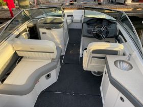 Interior view of a modern boat showcasing comfortable seating and a well-equipped helm, perfect for a day on the water.