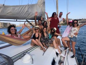 A lively group of friends celebrates aboard a yacht, enjoying the sun and each other's company — perfect for memorable outings and adventures on the water.