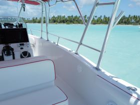 A clean and modern helm area of a boat, featuring comfortable seating and navigational equipment, perfect for a day out on the water.
