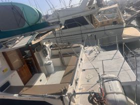 Interior view of a boat's helm and seating area, showcasing a well-equipped cabin perfect for comfortable cruising.