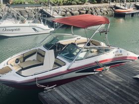 A sleek Yamaha boat docked at the marina, showcasing its stylish design and comfortable seating, perfect for a day on the water.