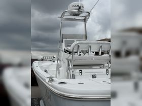 A detailed view of a sleek center console boat, showcasing its modern design and features, perfect for fishing or leisure outings.